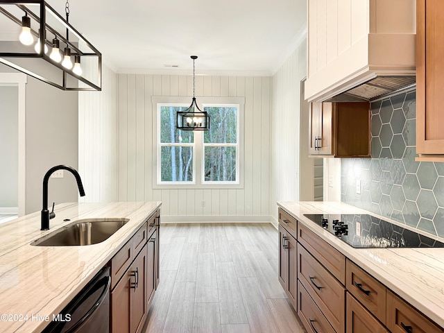 kitchen with sink, tasteful backsplash, decorative light fixtures, custom range hood, and ornamental molding