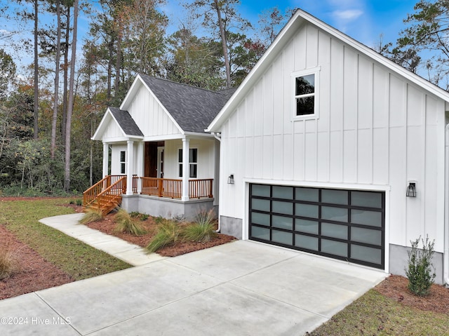 modern farmhouse featuring a garage and covered porch