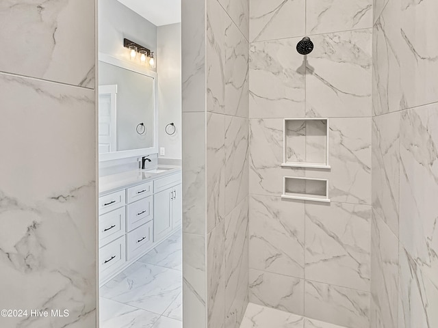 bathroom featuring vanity and tiled shower