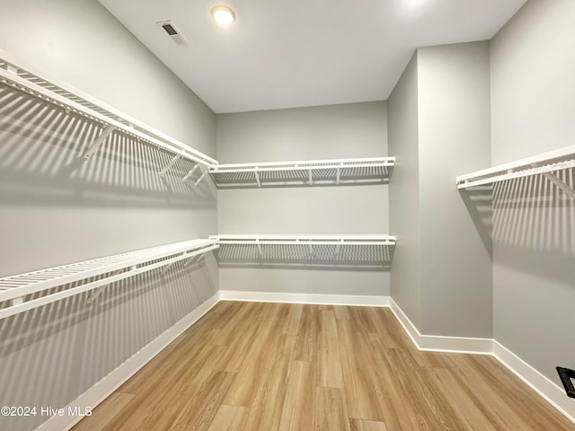 walk in closet featuring hardwood / wood-style floors