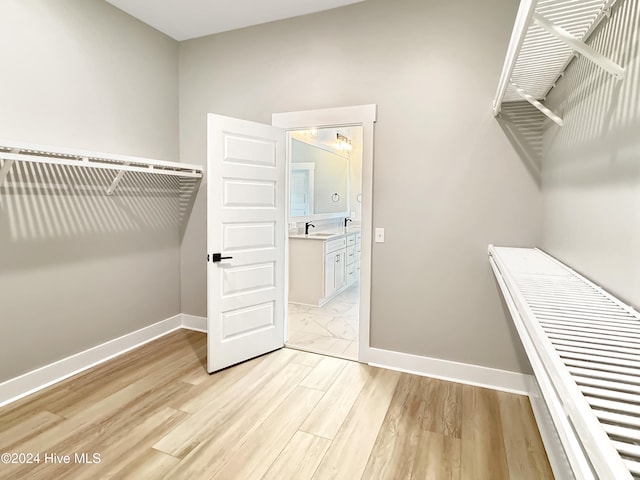 spacious closet with light hardwood / wood-style floors