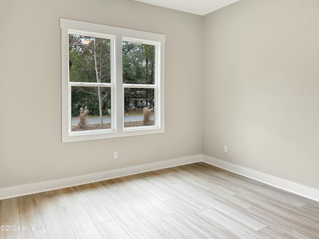 unfurnished room with light hardwood / wood-style floors