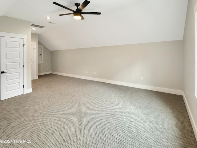 additional living space featuring carpet flooring, ceiling fan, and lofted ceiling