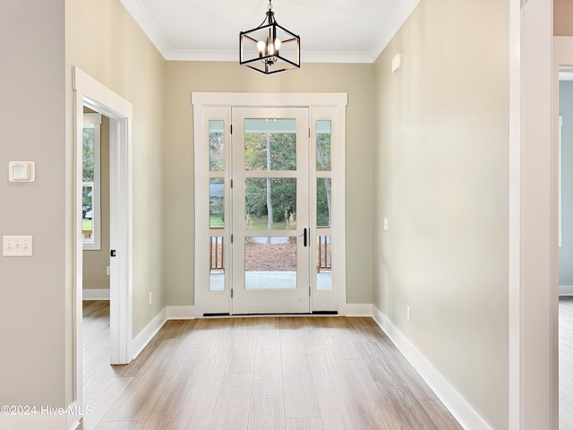 entryway with plenty of natural light, light wood-type flooring, and ornamental molding