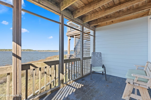 sunroom featuring beamed ceiling, a water view, and wooden ceiling