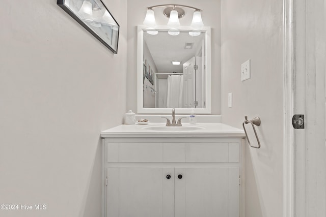 bathroom with vanity and curtained shower