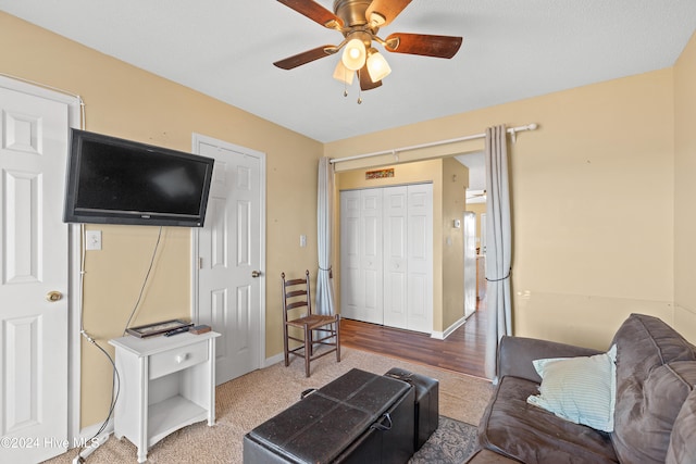 living room featuring hardwood / wood-style flooring and ceiling fan