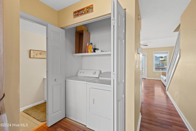 washroom with washer and dryer, hardwood / wood-style floors, and a textured ceiling