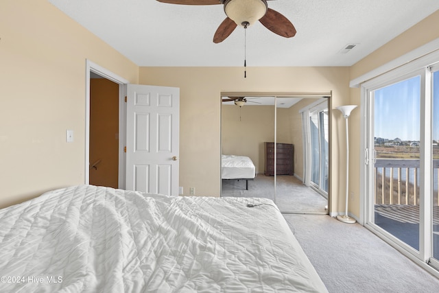 carpeted bedroom with access to exterior, a textured ceiling, a closet, and ceiling fan