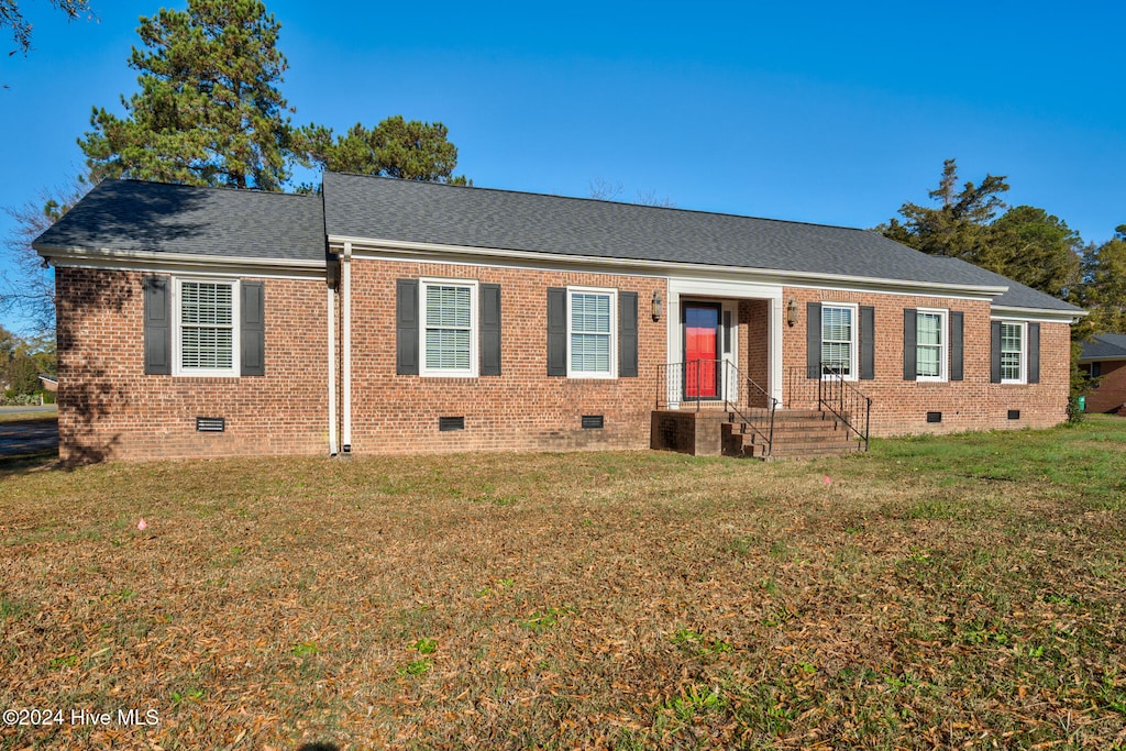 ranch-style home featuring central air condition unit and a front yard