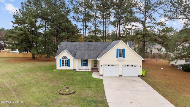 view of front facade with a front lawn, covered porch, and a garage