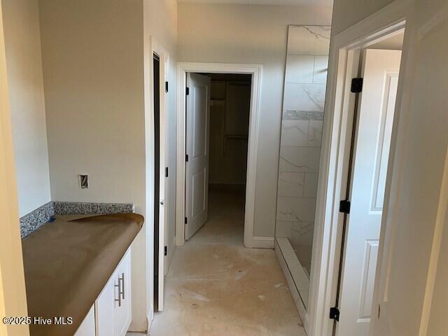 full bath with a stall shower and vanity