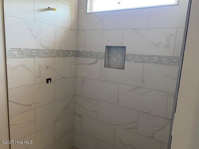 full bathroom with a tile shower