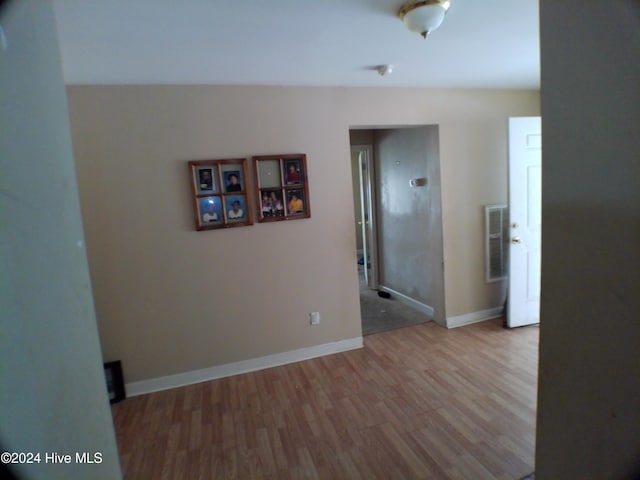 empty room with hardwood / wood-style flooring