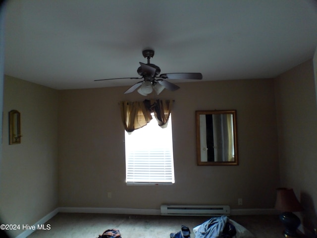 spare room with carpet floors, a baseboard radiator, and ceiling fan