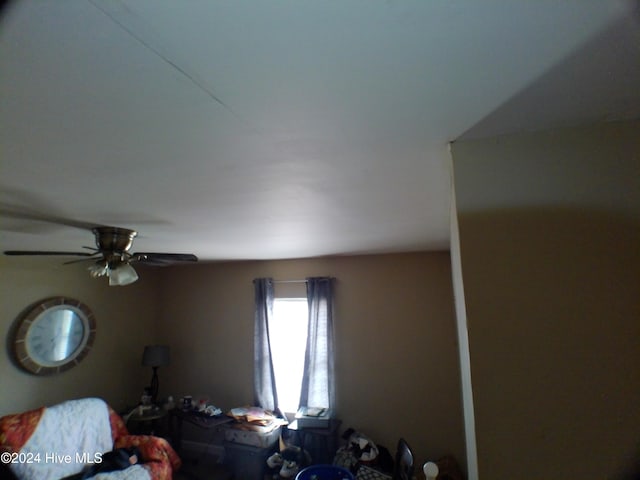 interior space with ceiling fan