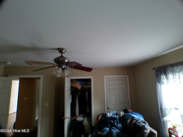 bedroom with ceiling fan and a closet