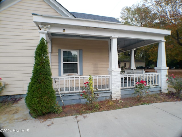 view of property exterior with a porch