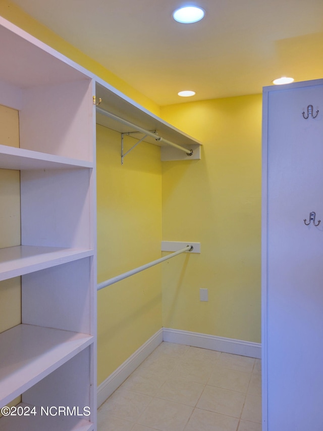 walk in closet with tile patterned floors