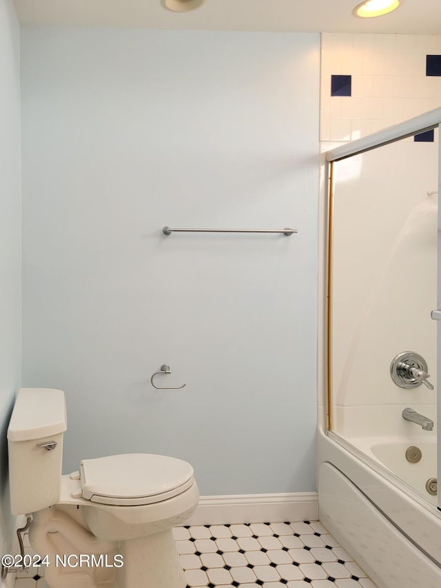 6111 Cutlass Ct, New Bern, NC 28560 - bathroom with toilet, baseboards, and bath / shower combo with glass door