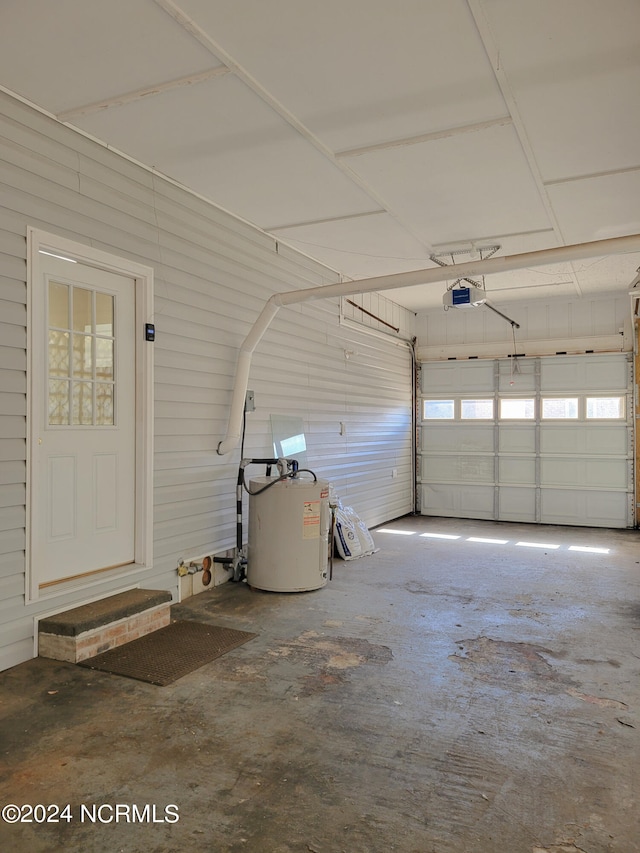 garage featuring electric water heater and a garage door opener