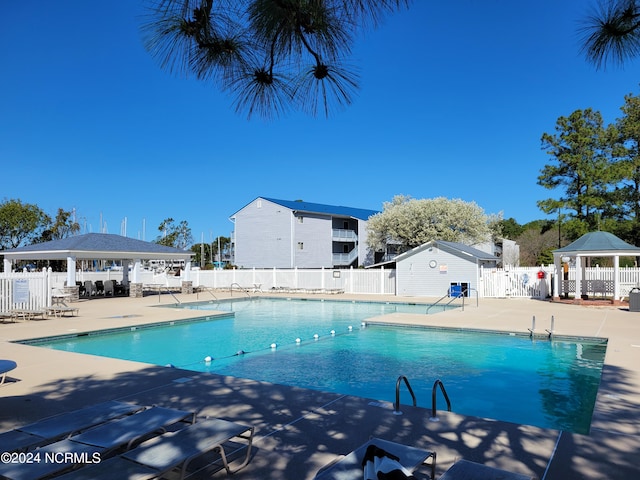 view of pool featuring a gazebo and a patio