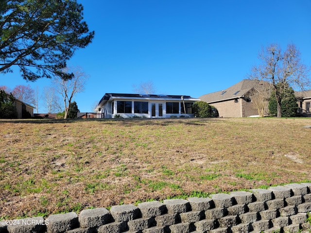 6111 Cutlass Ct, New Bern, NC 28560 - back of property with french doors, a sunroom, and a lawn