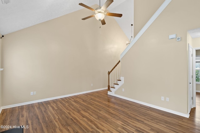 unfurnished living room featuring ceiling fan, dark hardwood / wood-style flooring, and high vaulted ceiling