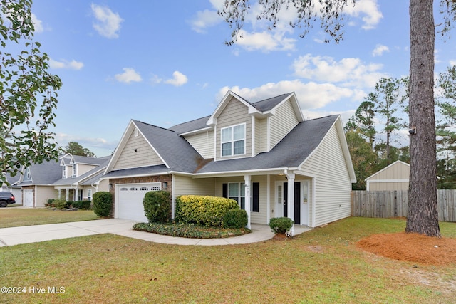 view of front of house with covered porch, a front yard, and a garage