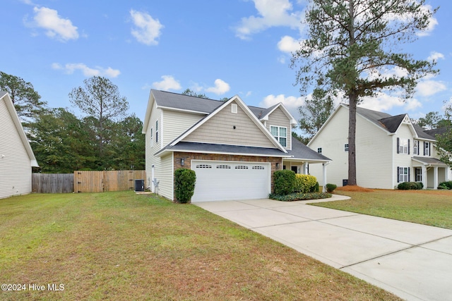 view of front facade with a front yard, a garage, and central AC unit