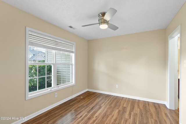 empty room featuring ceiling fan, a textured ceiling, and hardwood / wood-style flooring