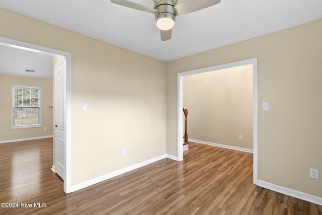 spare room featuring hardwood / wood-style floors and ceiling fan