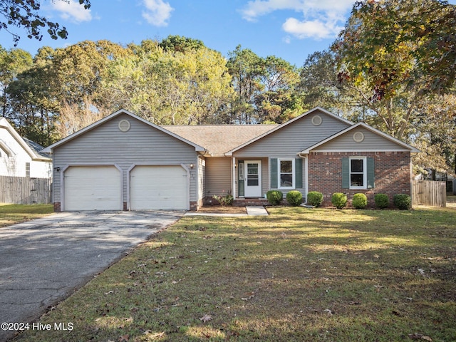 ranch-style home featuring a front lawn and a garage