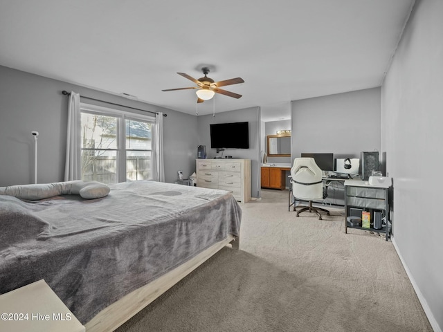 bedroom with ceiling fan and light carpet