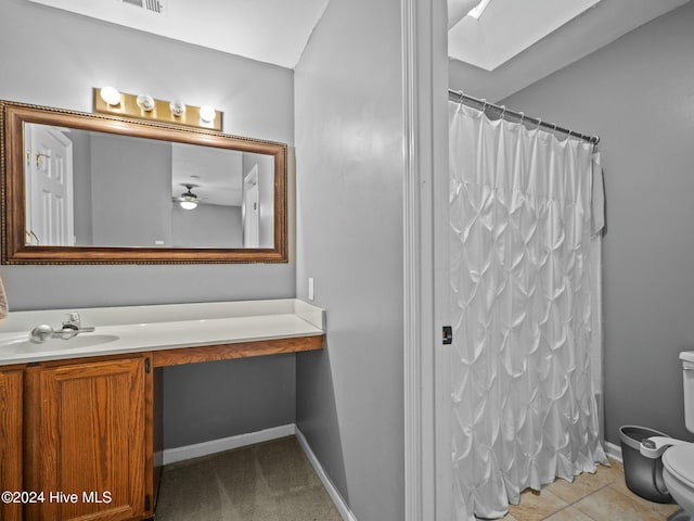 bathroom with a shower with shower curtain, vanity, ceiling fan, tile patterned flooring, and toilet