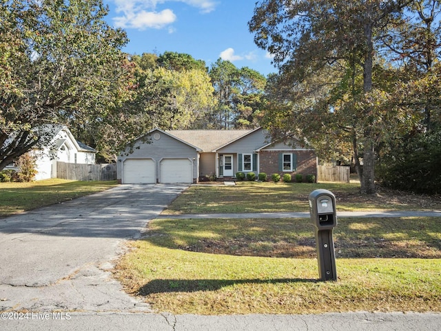 ranch-style home with a garage and a front lawn