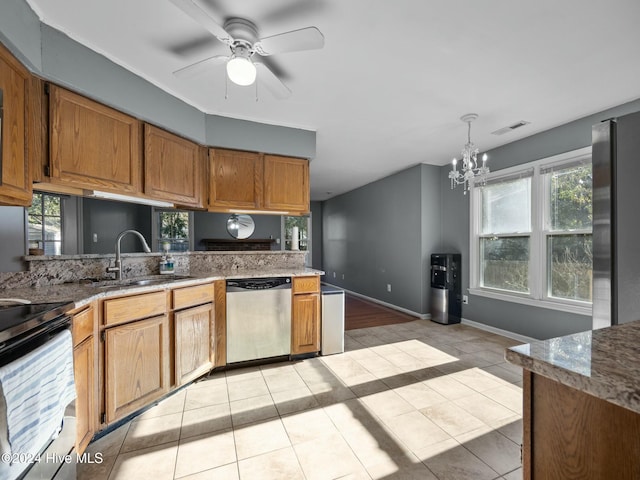 kitchen featuring ceiling fan with notable chandelier, sink, appliances with stainless steel finishes, decorative light fixtures, and light tile patterned flooring