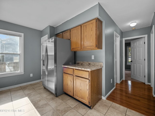 kitchen featuring stainless steel fridge and light wood-type flooring