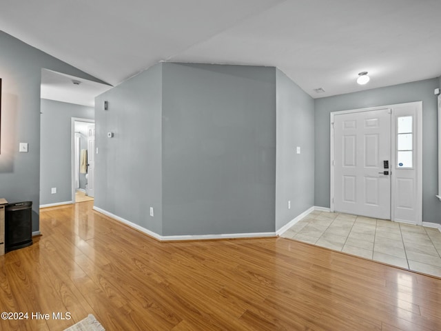 entrance foyer featuring light hardwood / wood-style floors and lofted ceiling