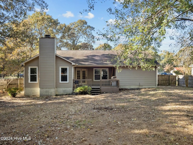 back of house featuring a wooden deck