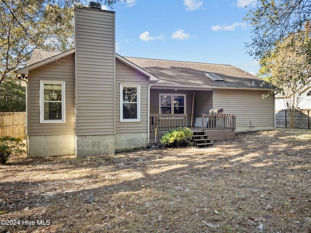 rear view of house featuring a wooden deck