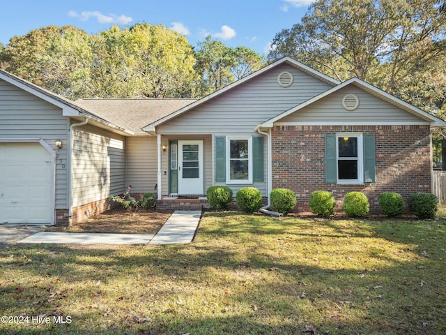 ranch-style house with a garage and a front lawn