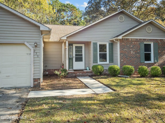 single story home with a garage and a front lawn