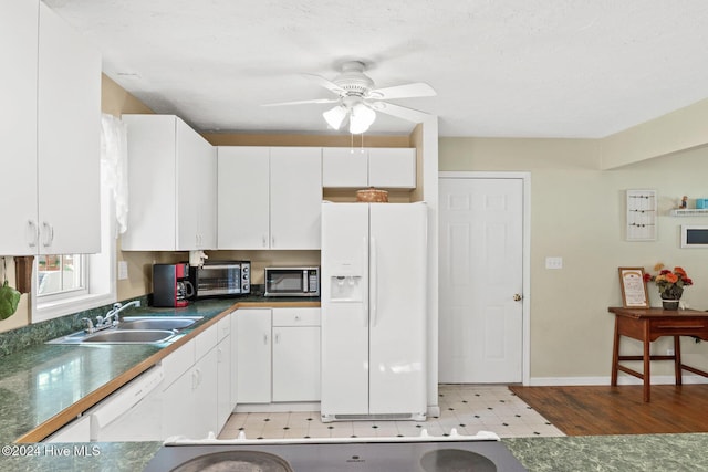 kitchen featuring white appliances, ceiling fan, sink, light hardwood / wood-style flooring, and white cabinetry