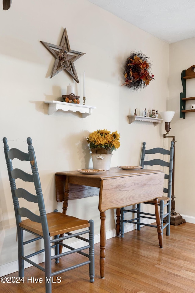 dining area with hardwood / wood-style floors