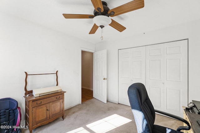 home office featuring light carpet and ceiling fan