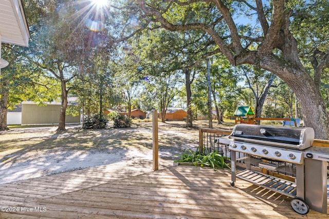 wooden terrace featuring area for grilling