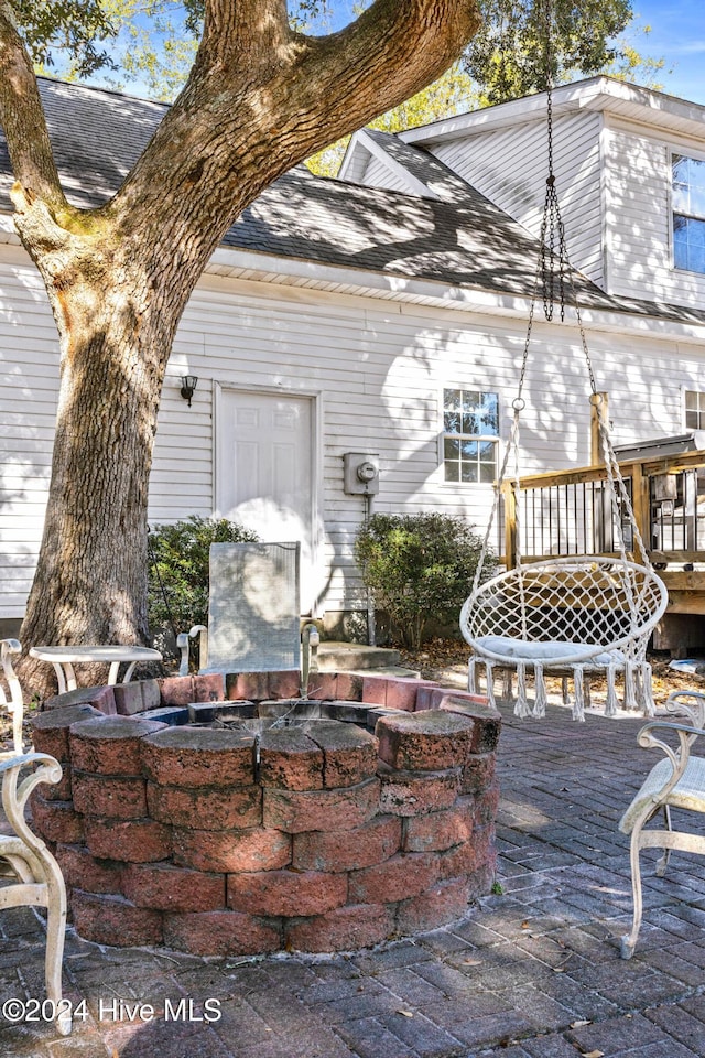 view of patio featuring a fire pit and a wooden deck