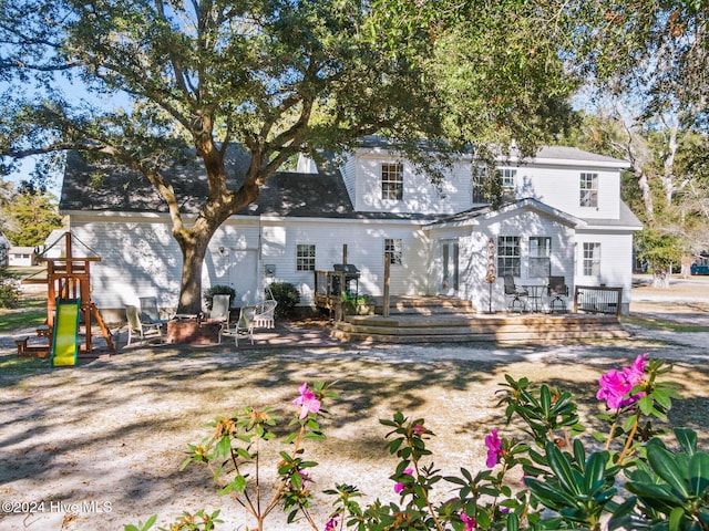 back of property featuring a wooden deck