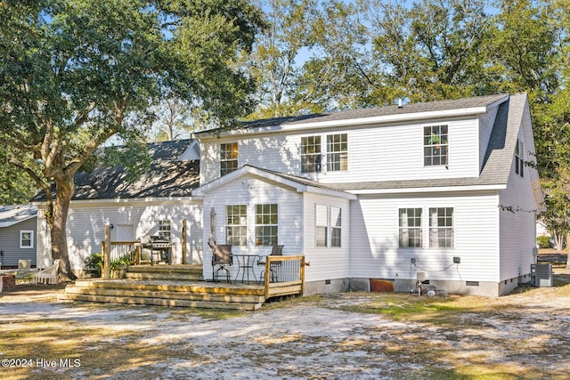 view of front of home featuring cooling unit and a deck